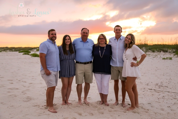 Whole family with the beautiful sunset behind them at Johnsons Beach in Perdido Key 