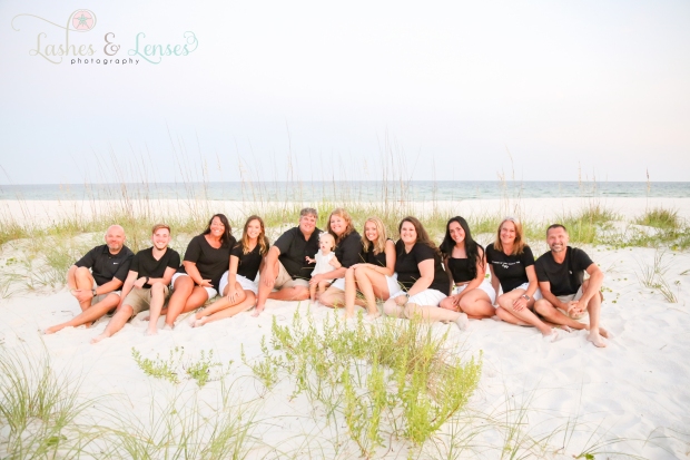 Large family sitting in the sand at Johnsons Beach in Perdido Key