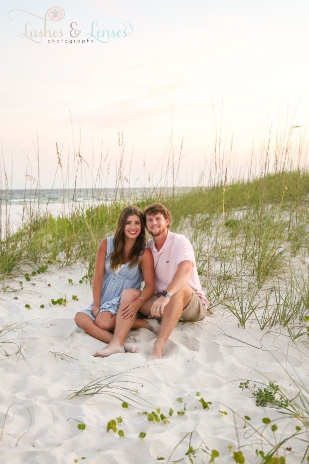 Young adult couple sitting in the sand at Johnsons Beach in Perdido Key