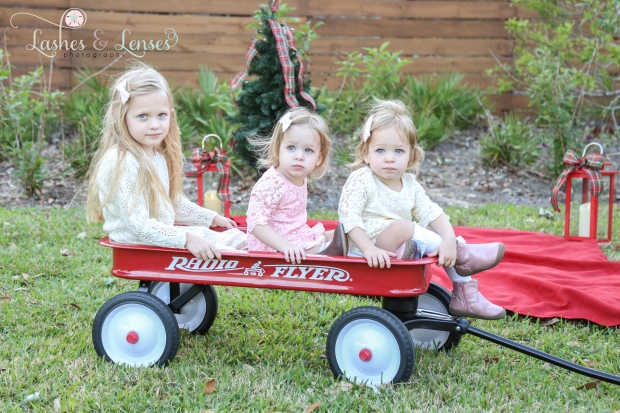 Pre-K girl and twin toddler sisters in the radio flyer wagon with Christmas tree at Innerarity Point Park