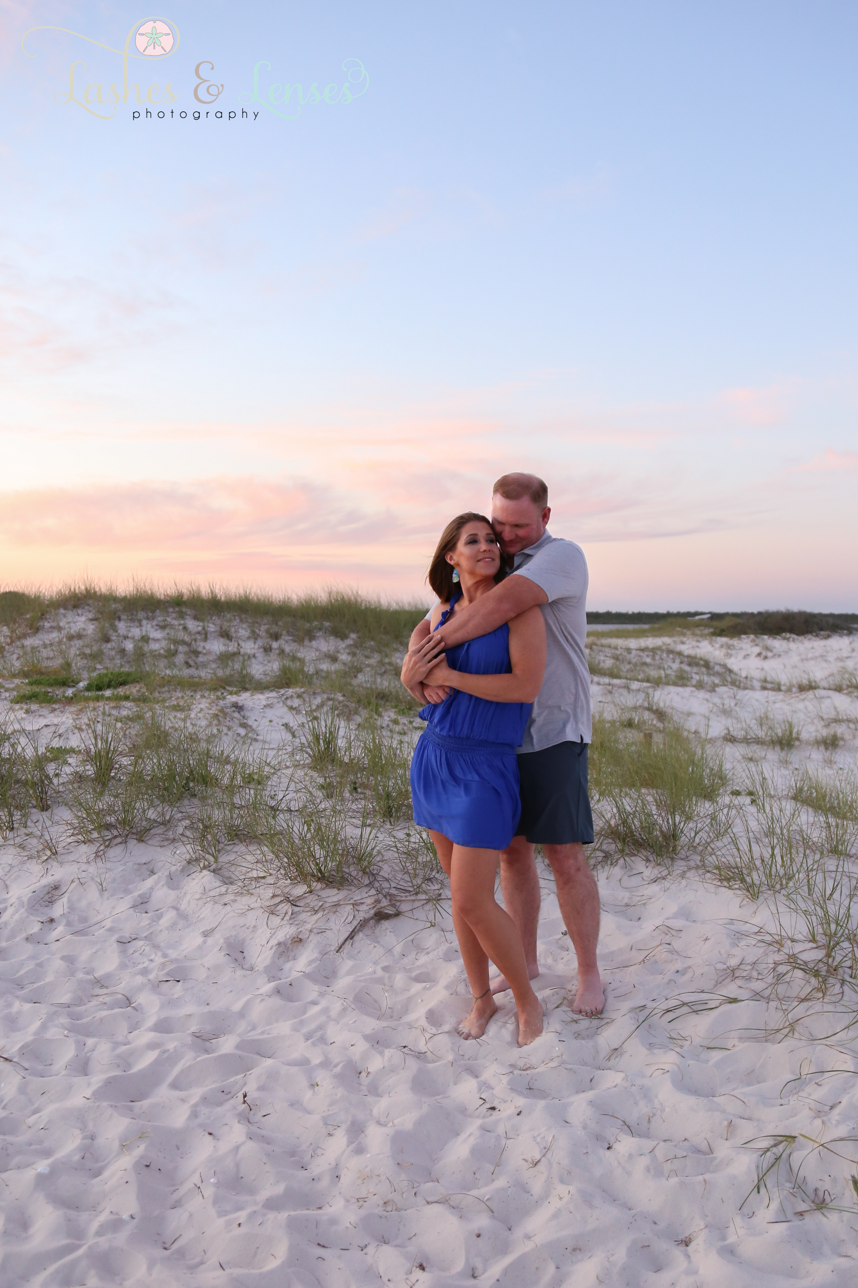 Married couple with the sunset behind them  at Johnsons Beach in Perdido Key Florida