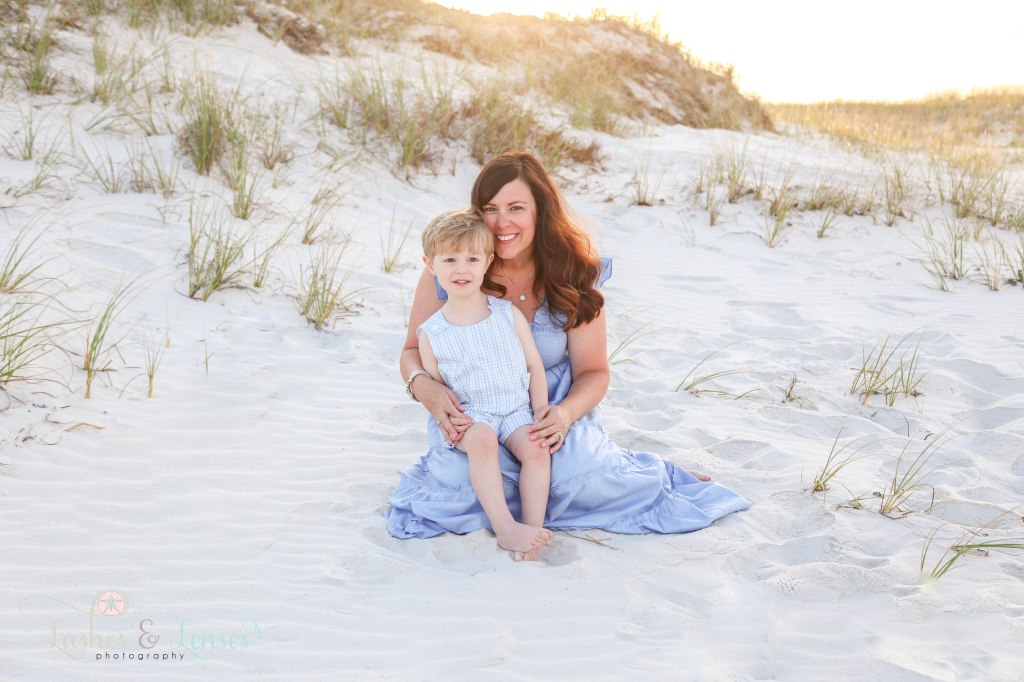 Mom sitting in the sand wither toddler son at Johnsons Beach in Perdido Key Florida