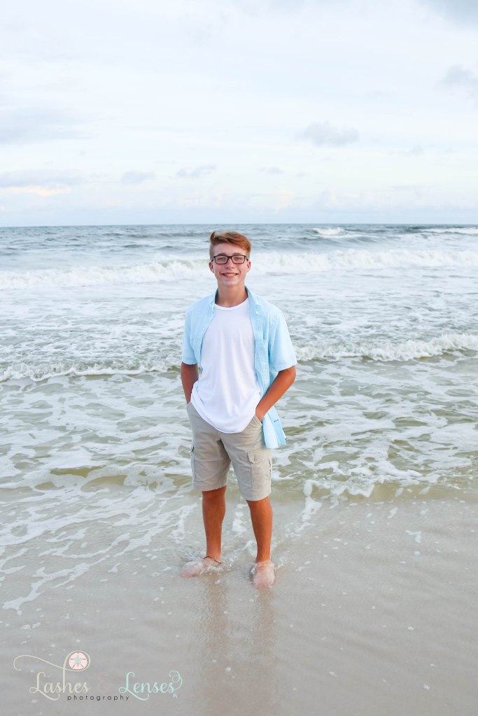 Young teen boy standing in the water at Johnsons Beach in Perdido Key Florida