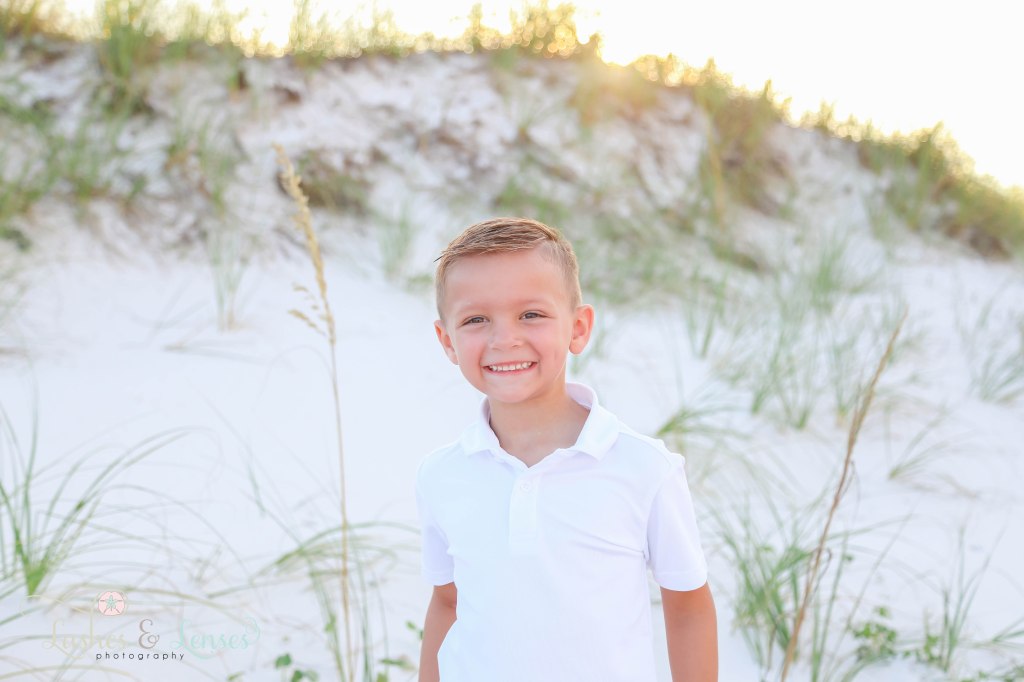 Close up photo of young boy with the sunset behind them at Johnsons Beach in Perdido Key Florida