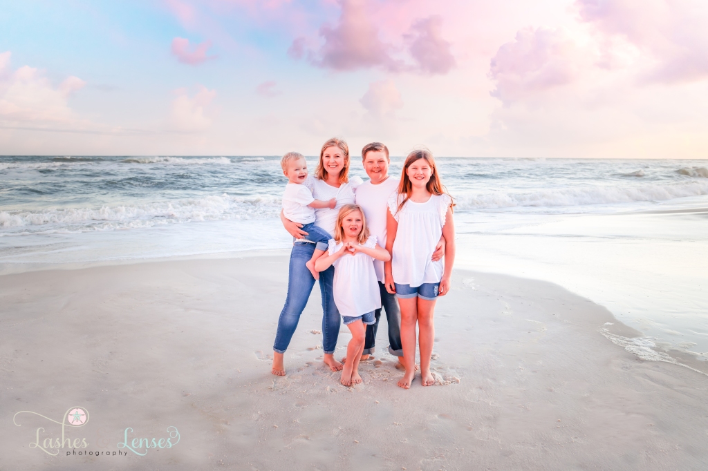 Mom with her four children standing at the edge of the water at Johnsons Beach in Perdido Key, Fl