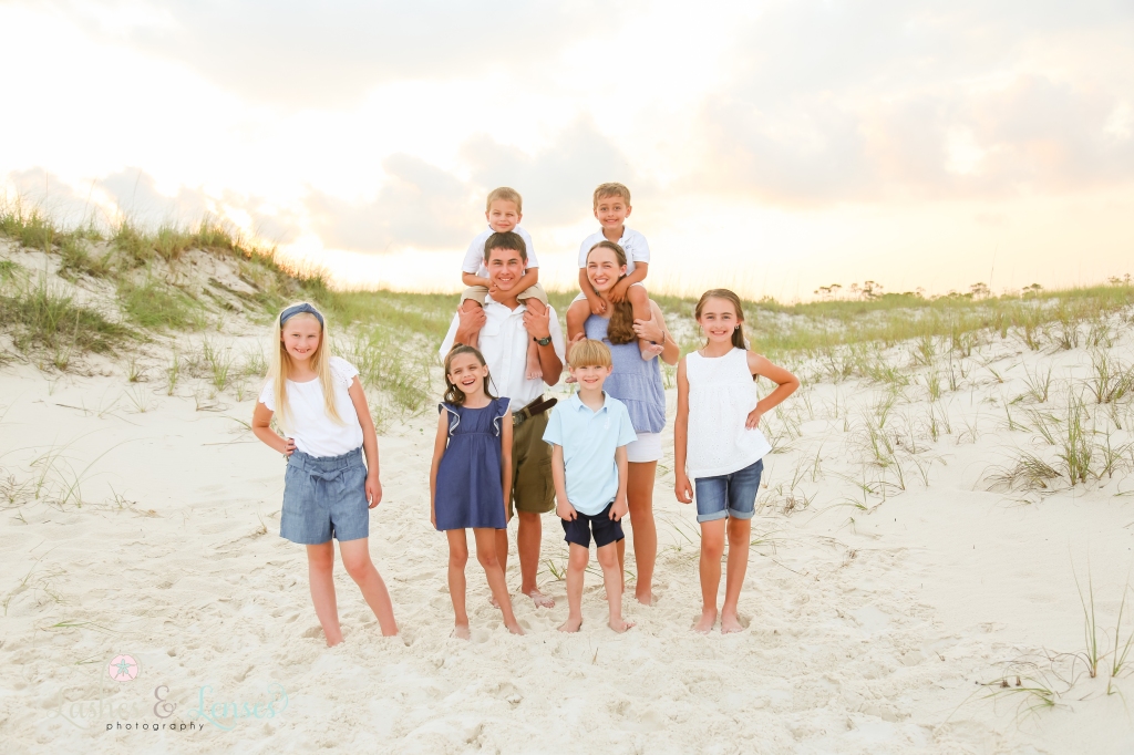 Eight cousins with the sunset behind them at Johnsons Beach in Perdido Key, Florida