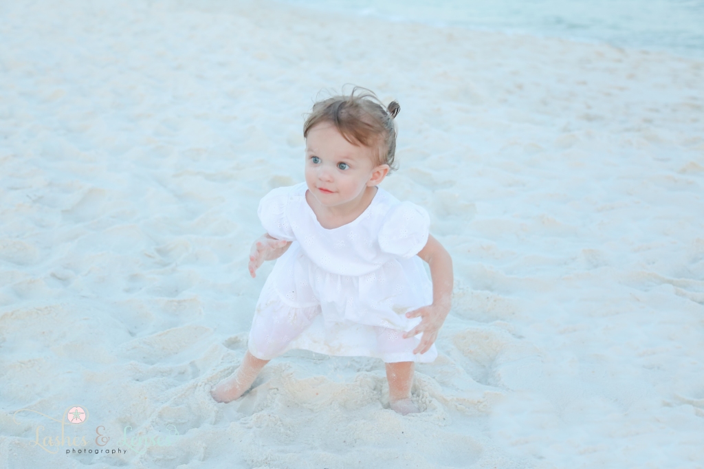 Toddler girl playing in the sand at Johnsons Beach in Perdido Key, Florida