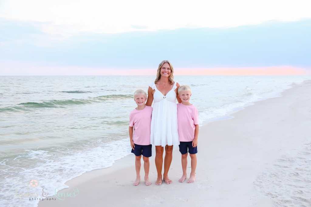 Mom and her two twin boys standing next to the water with the sunset behind them at Johnson's Beach in Perdido Key, Florida