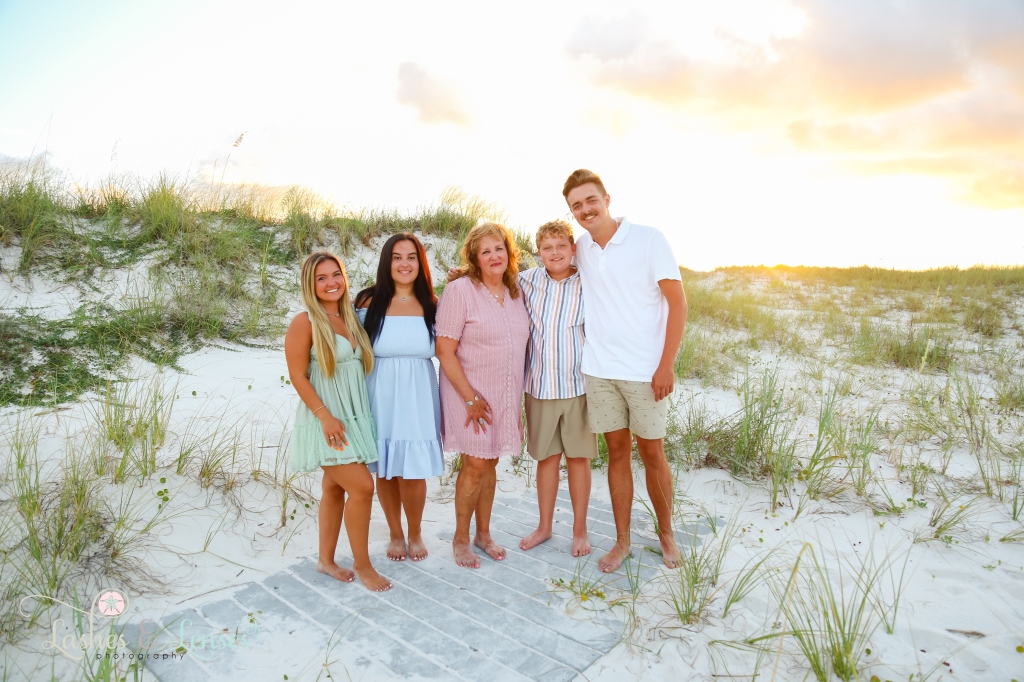 Grandma with her four teen grandchildren at Johnson's Beach in Perdido Key, Florida